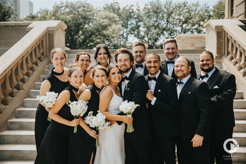 black attire for wedding party at the foot of the stairs Vanessa with Complete Weddings + Events Omaha wedding photographer