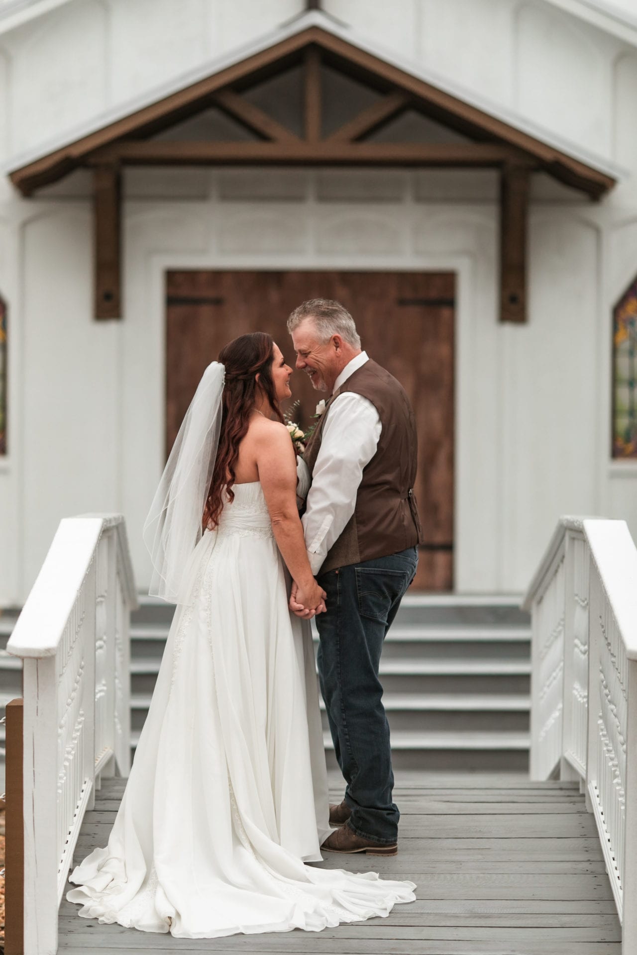 Wedding couple outside of a chapel after wedding ceremony at The Hidden Barn wedding venue