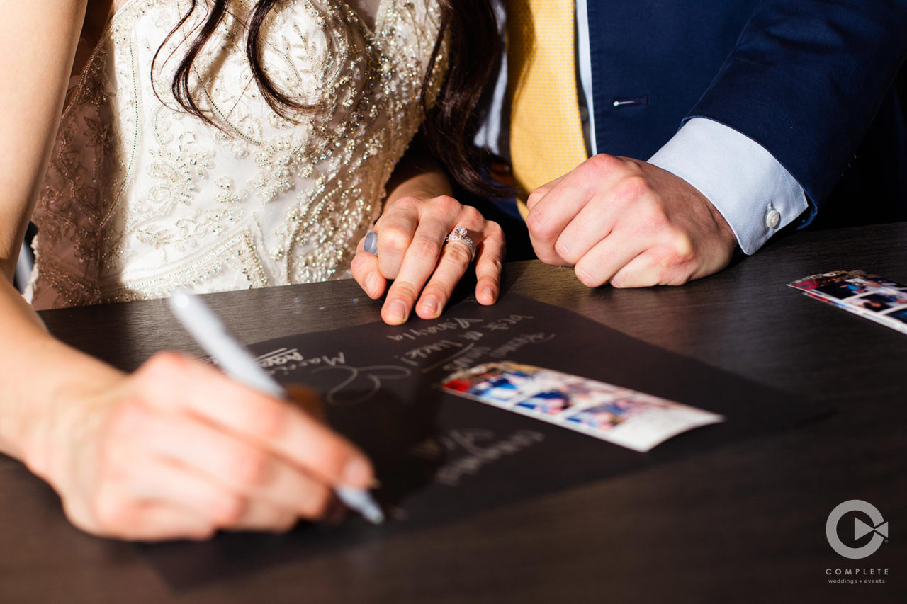 Photo booth scrapbook at Venue 1902 guests signing scrapbook