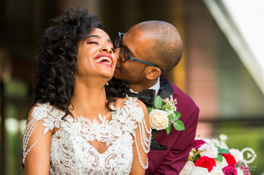 Bride laughs as groom kisses her cheek beautiful Orlando photography