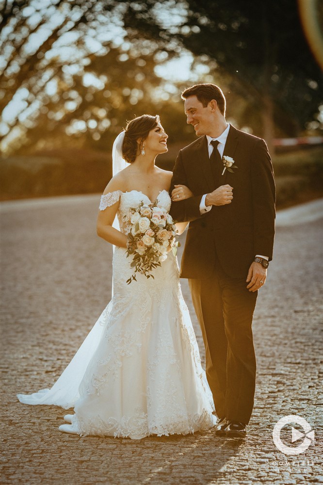 Bride and groom on a pebble road during February wedding in West Orlando
