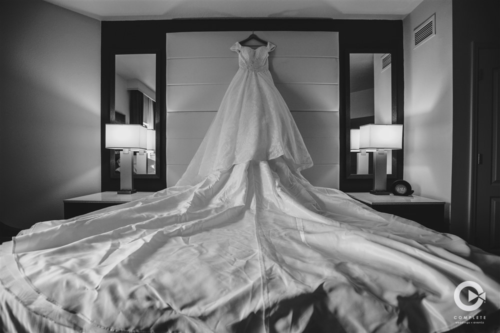 Wedding dress on a bed in black and white late Orlando November wedding