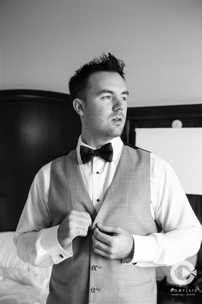 Late November wedding in Orlando groom getting ready photo in black and white vertical photo