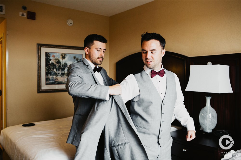 Late November Naimi and Kelton Orlando wedding groom putting suit on