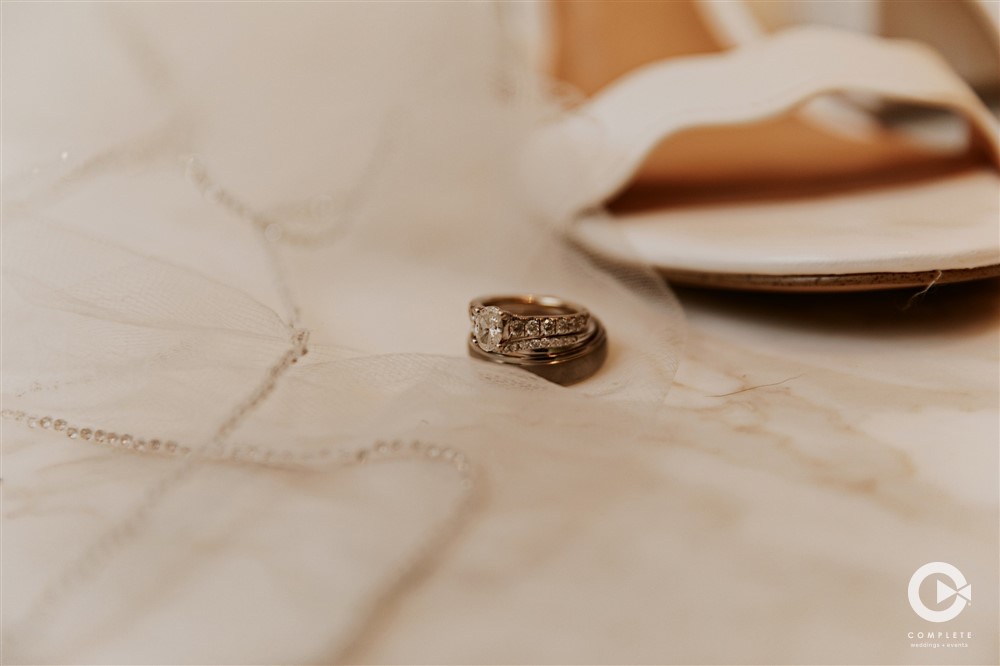 Wedding rings near shoes on the floor wedding detail shot