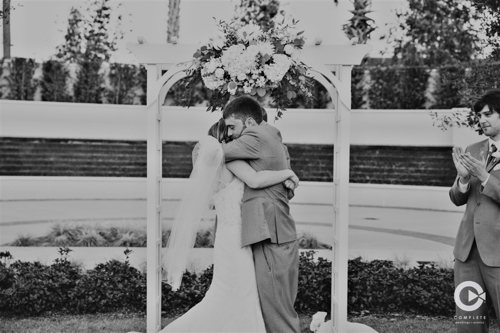 The Omni Resort Orlando wedding ceremony bride and groom hugging at the end of the ceremony