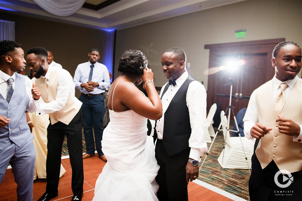 Bride and groom dancing at Embassy Suites Orlando Lake Buena Vista during September wedding