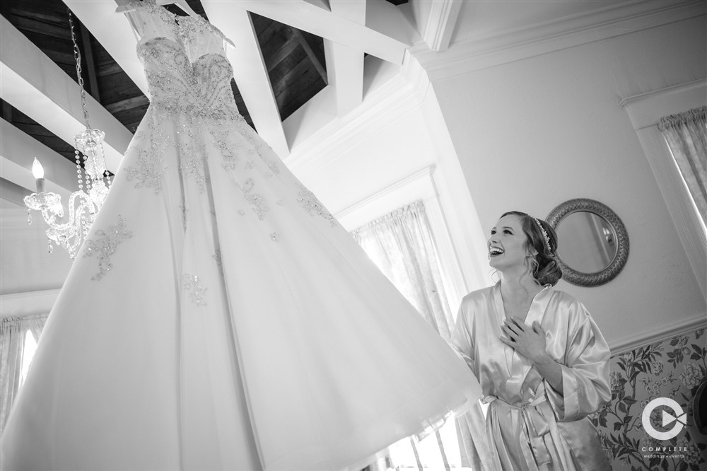 Bride looking up at her wedding dress in black and white gorgeous photo