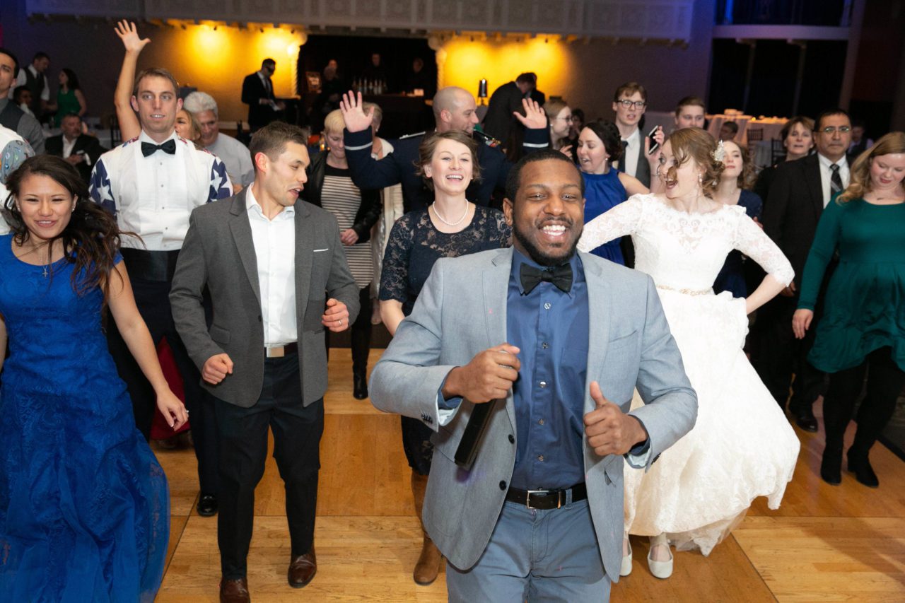 DJ leads group dance during the Wobble at Lake Mary wedding reception