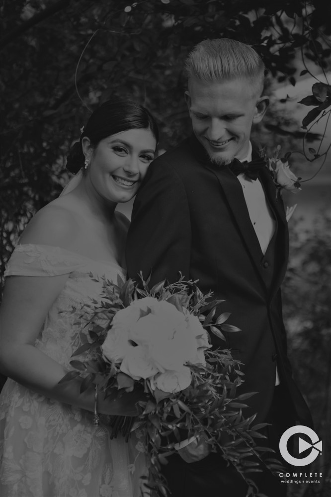 Bride and groom hugging in black and white at The Garden Villa