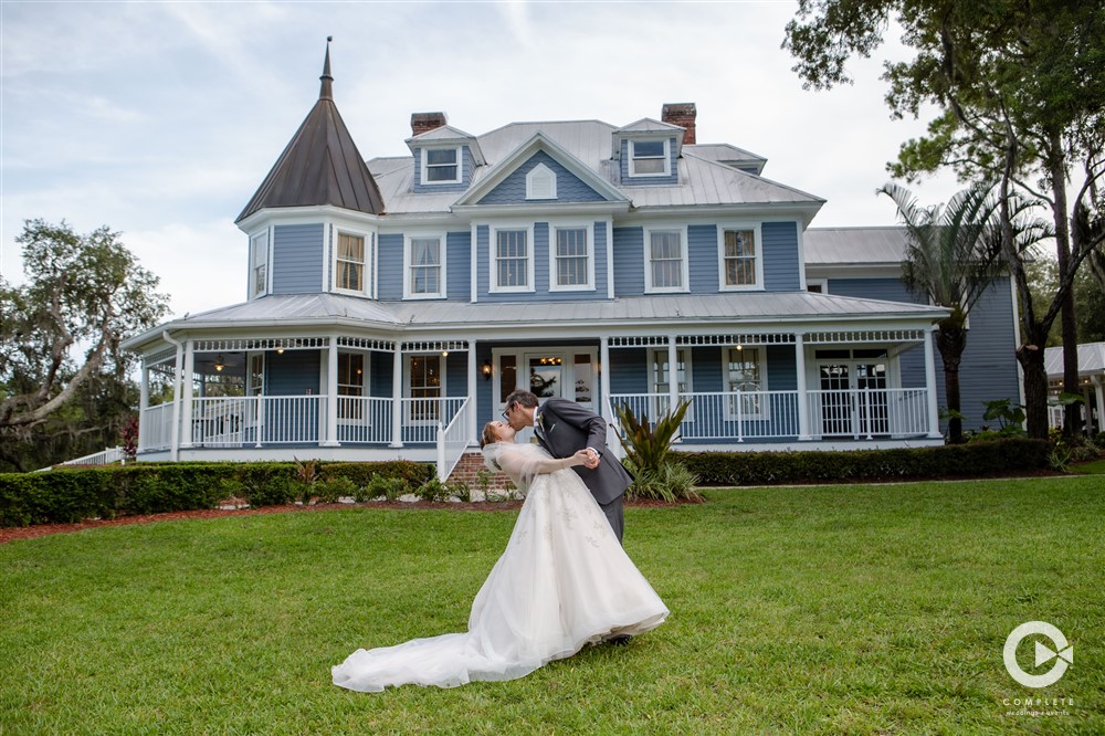 Photo of bride and groom kissing outside of The Highland Manor during late Summer 2021 wedding