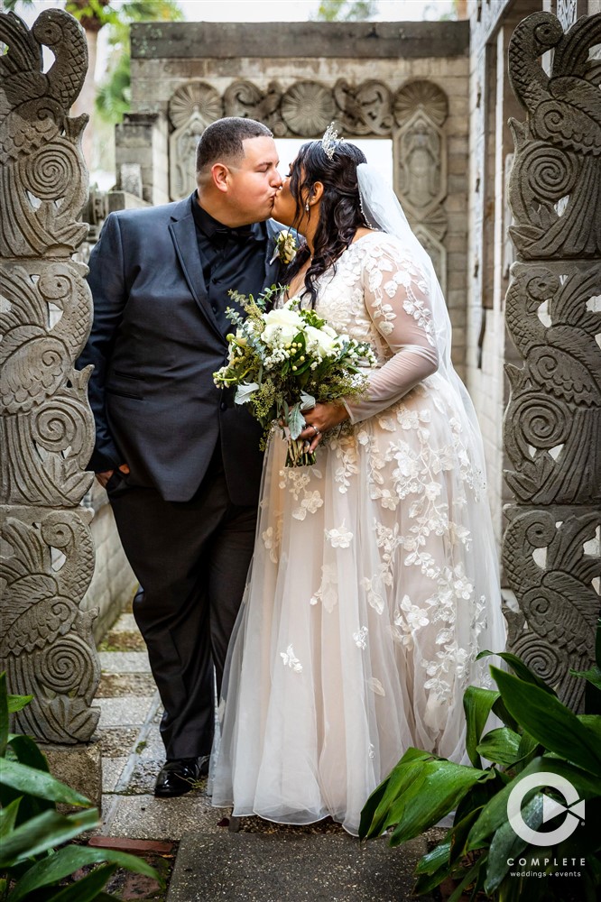 Gorgeous couple kissing at their beautiful wedding reception in Orlando November wedding