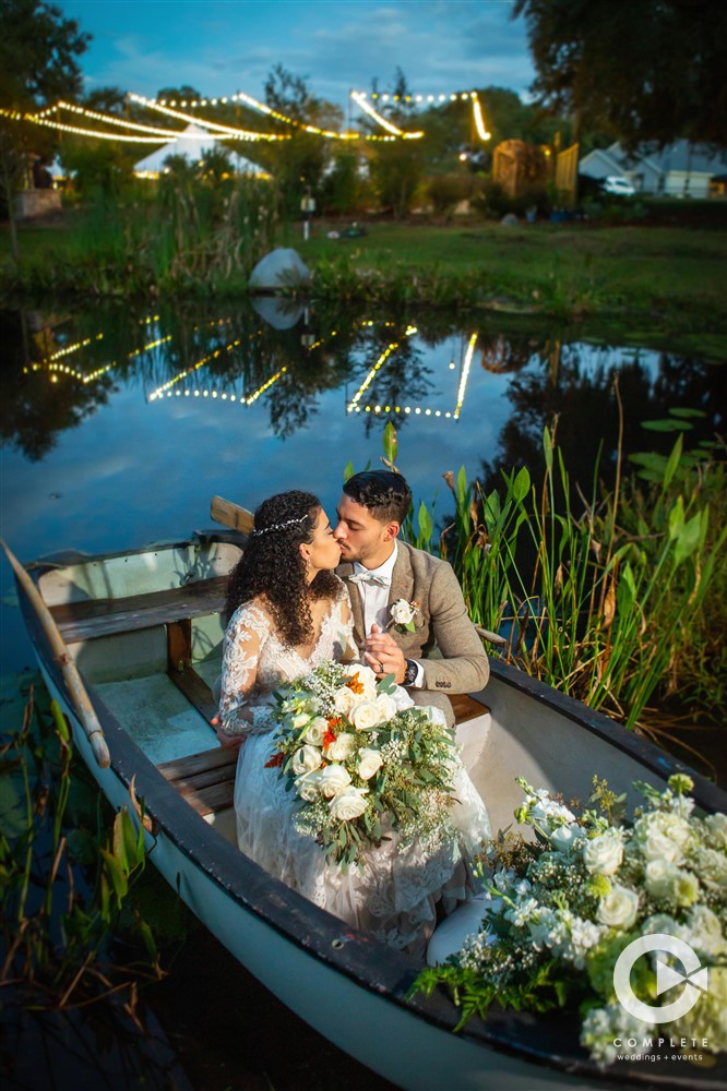 Couple on a boat during their wedding outdoors in the late Fall