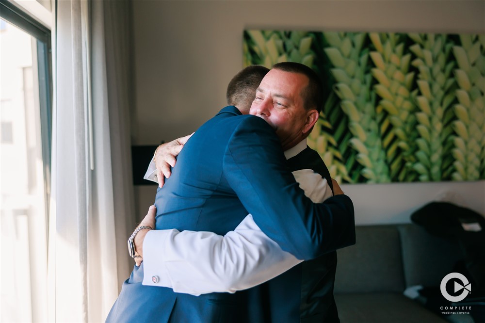 Groom hugs his father before his Reunion Resort wedding ceremony beautiful moment