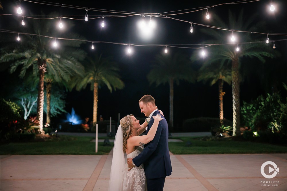 Outdoor low light photo of couple dancing together at their wedding reception
