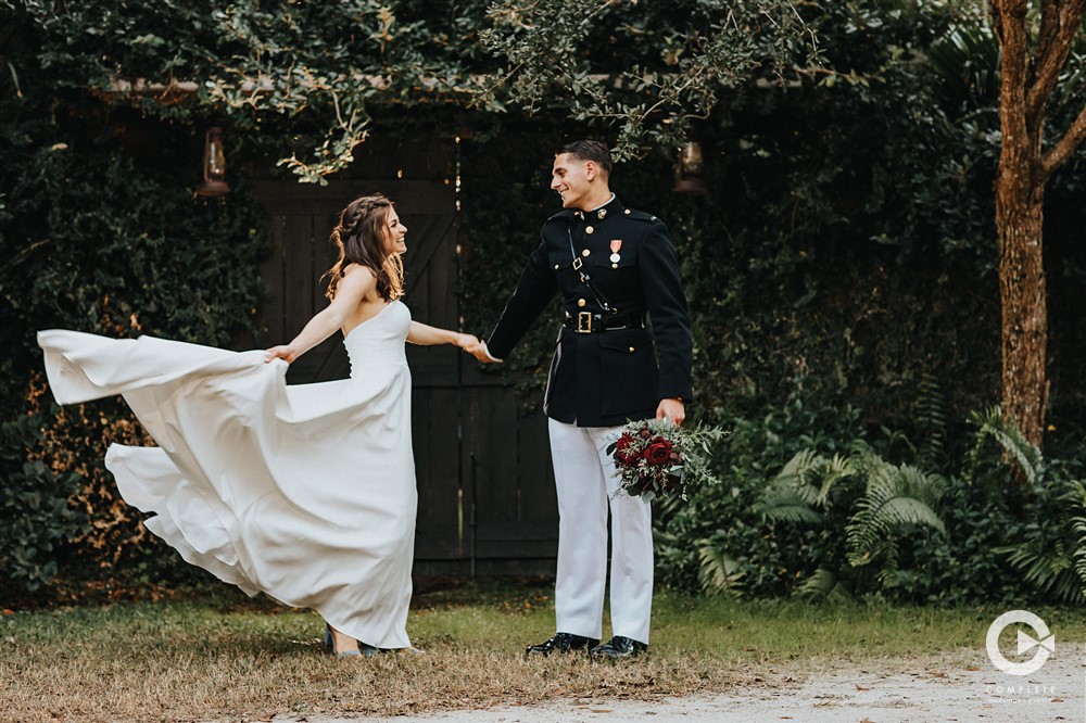 Bride and groom with wedding dress flowing in wind beautiful