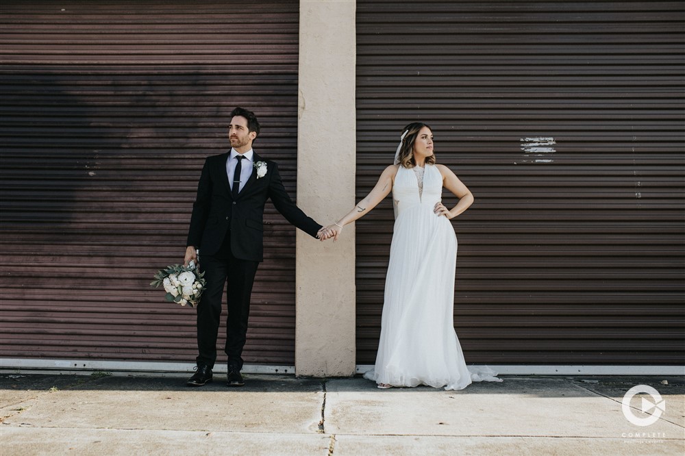 Bride and groom holding hands during their Downtown Orlando wedding reception