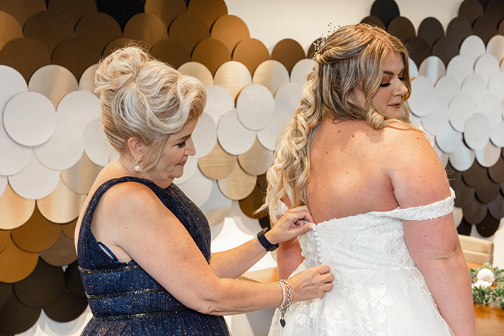 Mother Helping Daughter in Wedding Dress at Disney Springs