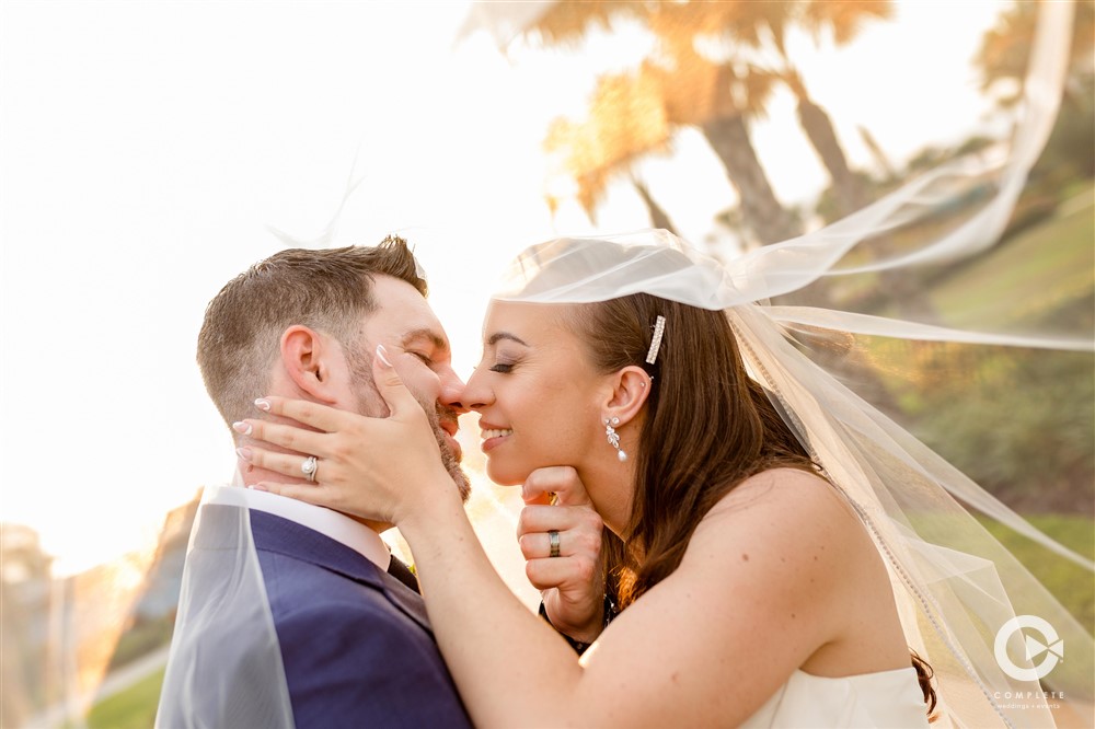 Bride and groom kissing at Margaritaville Resort Orlando beautiful wedding in May