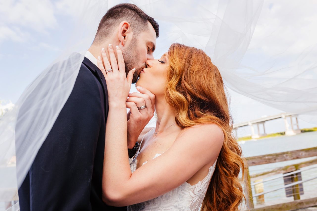 Bride and groom kissing at The Brannon Center in New Smyrna amazing wedding photo
