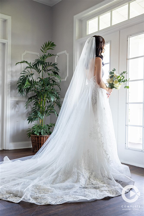 Orlando, FL bride looks out window on her wedding day