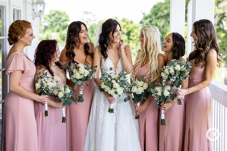 Tuscawilla bride and her bridesmaids laughing while taking photos