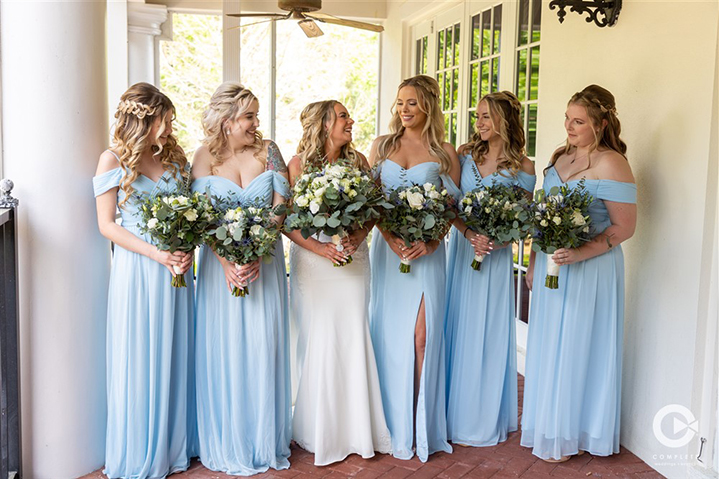 Bride and bridesmaids candidly laughing at Luxemore Grande Estate in Orlando, FL