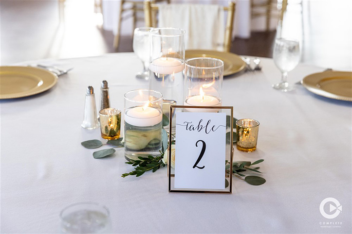 Gold dinnerware placed on table during Orlando, FL reception