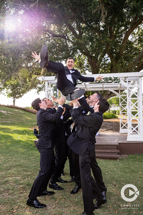 Groomsmen throwing with groom at Tuscawilla Country Club