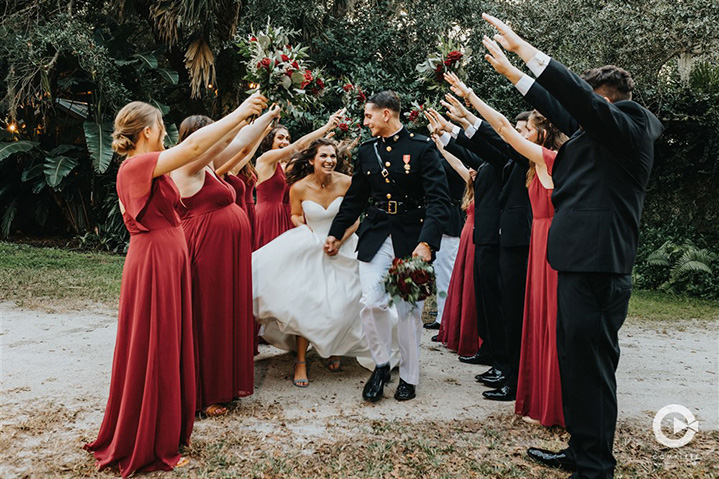 Bride and groom run through a tunnel their wedding party made in Orlando, FL at Delamater House