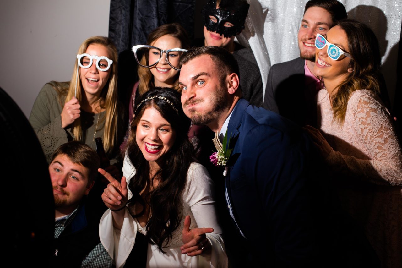 Wedding guests have fun in photo booth during spring wedding