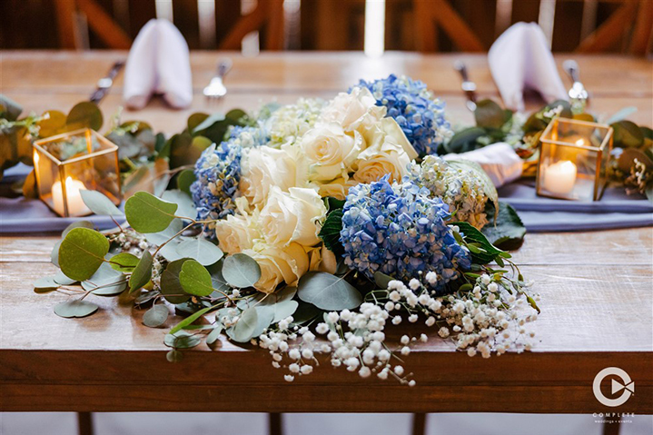 Table decorations with blue and baby's breath at The Mulberry in New Smyrna Beach
