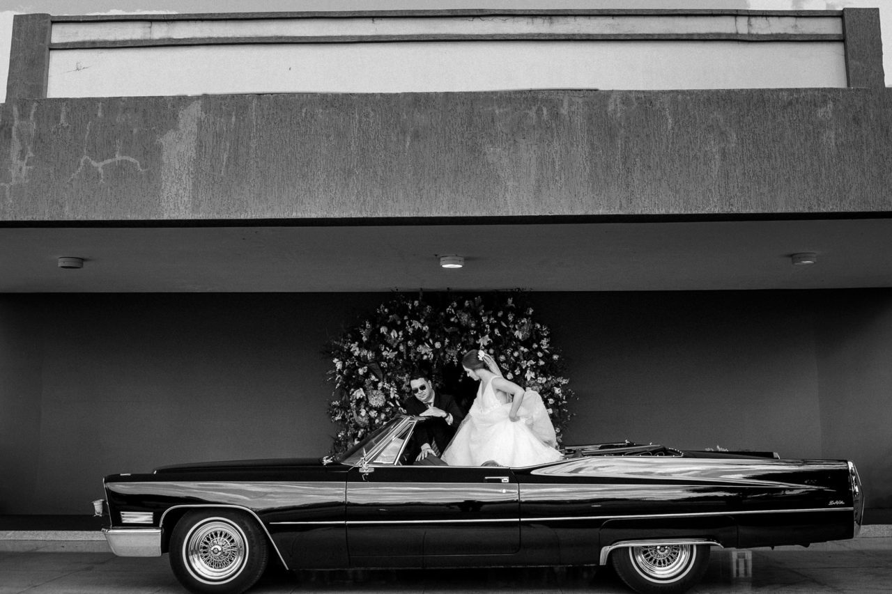 Wedding couple in a car after their wedding artsy shot by Rudy