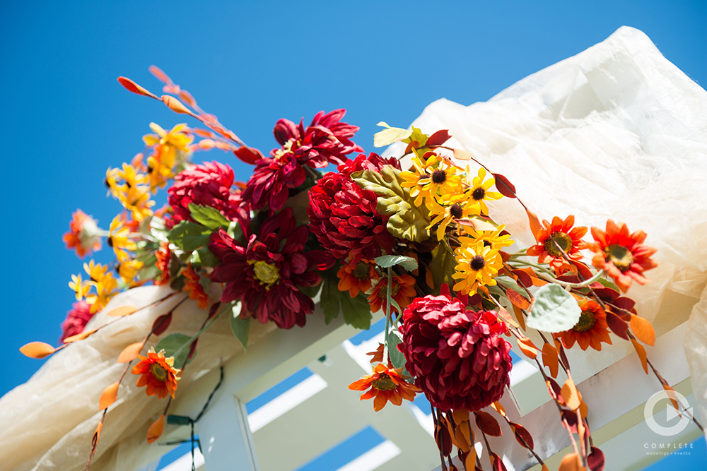 Beautiful Autumn wedding colors on an arch at Island Grove in Orlando