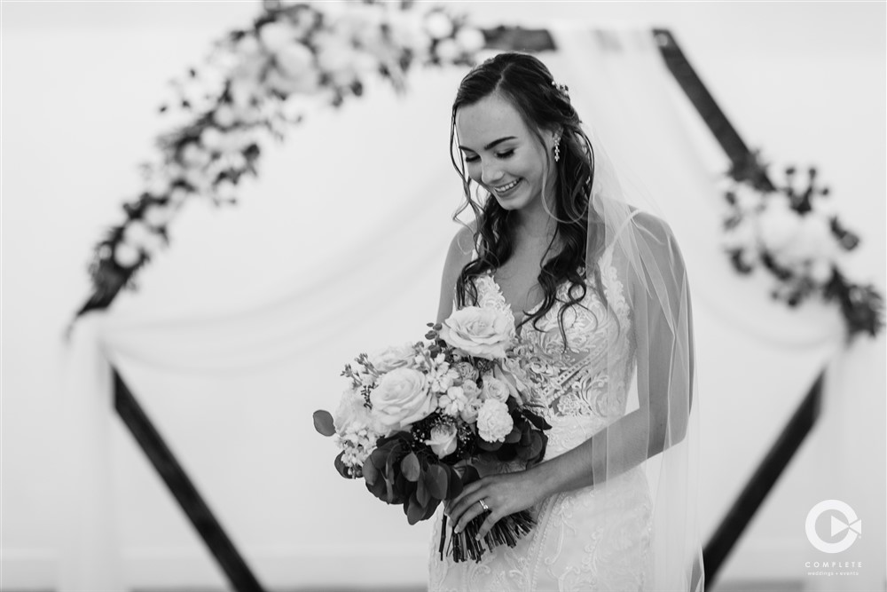 Bride smiling with her bouquet at her New Smyrna wedding ceremony