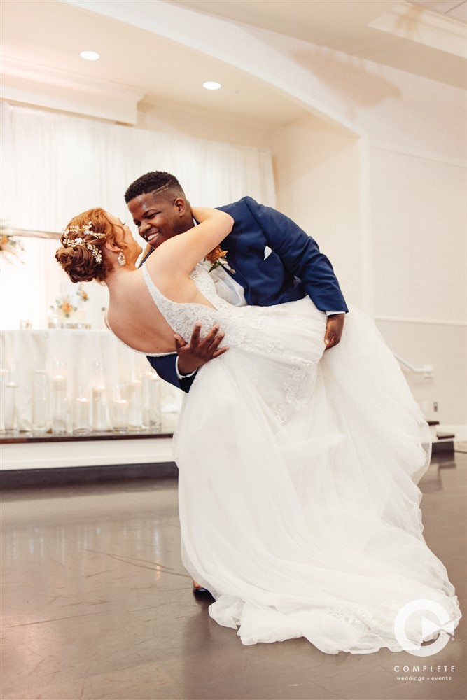 Groom holding his bride during a first dance at Lake Mary Event Center in Lake Mary, FL