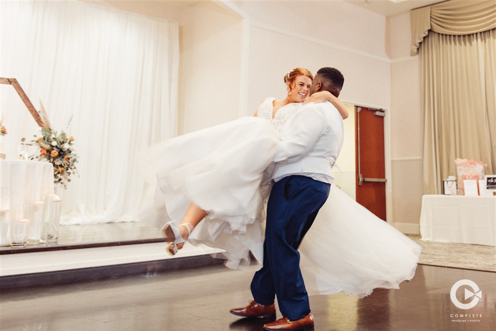 Groom twirling his bride during a wedding at Lake Mary Event Center first dance photo
