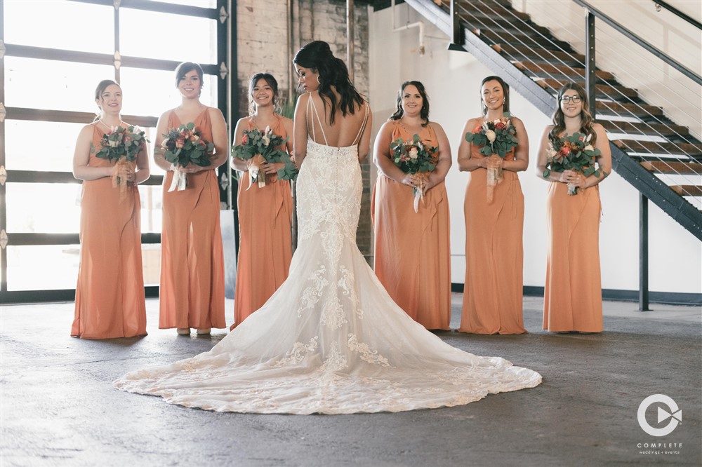 Bride with her bridesmaids wearing Autumn wedding colors beautiful shot