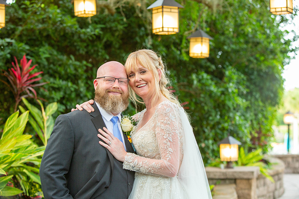 Bride and groom under the lights in Orlando during the day