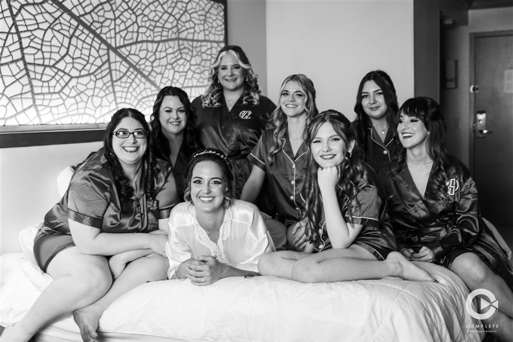 Bridesmaids on the bed hanging out in the bridal suite Renaissance Orlando.