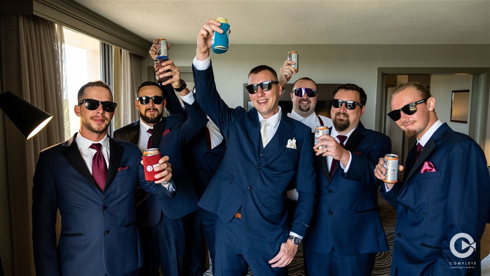 Groomsmen raising a glass before the wedding ceremony.