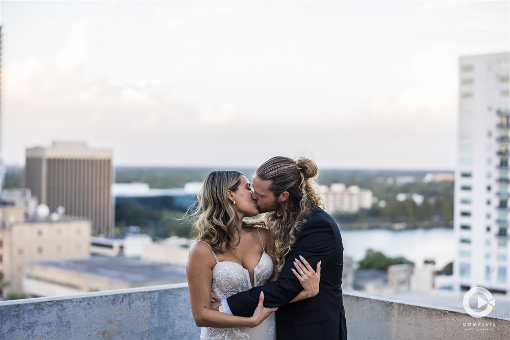 Bride and groom kissing at The Balcony in Orlando amazing wedding reception photo of the couple