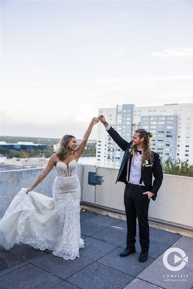 Bride and groom on a roof dancing together at The Balcony in Orlando, FL