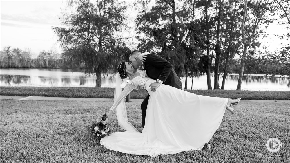 Wedding couple black and white photo groom dipping the bride after the ceremony awesome photography in Orlando