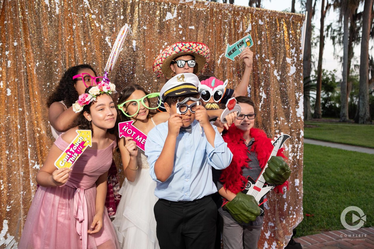 A group at a wedding in Orlando having fun with props at a Lake Mary wedding!