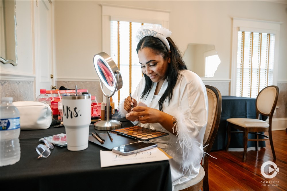 bride putting on makeup