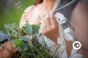 Bride holding veil and bridal bouquet on her wedding day