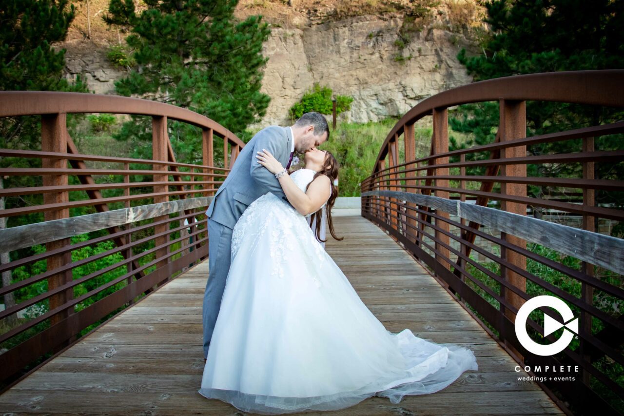 Bride and groom kissing on the bridge