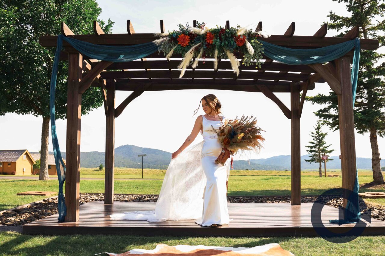 black hills fall wedding inspiration at elkhorn ridge ceremony arch teal and rust
