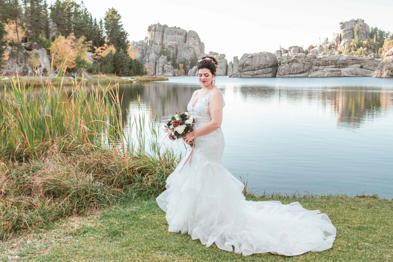 Bride standing by Sylvan Lake - destination wedding in South Dakota